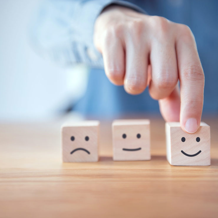 Wooden Blocks With Emojis Representing Emotional Styles