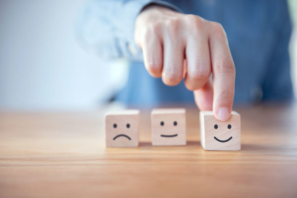 Wooden Blocks With Emojis Representing Emotional Styles